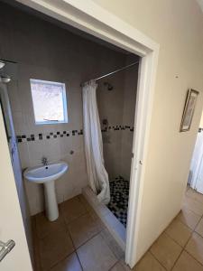 a bathroom with a shower and a sink at Pavlovna Bunk with the kids Cottage in Himeville