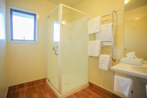 a bathroom with a shower and a sink at Abbots Hamilton – Hotel and Conference Centre in Hamilton