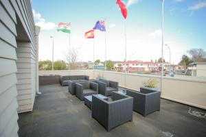 a row of chairs on a balcony with flags at Abbots Hamilton – Hotel and Conference Centre in Hamilton