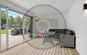a living room with a couch and a table at Gorgeous Home In Spøttrup With Sauna in Vester Lem