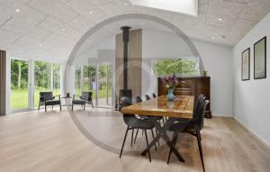 a dining room with a table and chairs at Gorgeous Home In Spøttrup With Sauna in Vester Lem