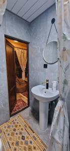 a bathroom with a sink and a mirror at Caravanà Resort in Yeghegnadzor