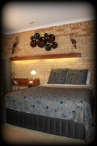 a bedroom with a bed with two birds on the wall at York's Boutique Motel in York