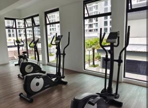 a row of exercise bikes in a room with windows at The Garden 2BR 4Pax Cozy Stylish Netflix BySTAY in Skudai