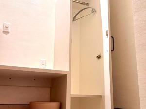a bathroom with a white cabinet and a toilet at HOTEL minimumms女性専用カプセルホテルWomen only hotel in Naha +118 photos