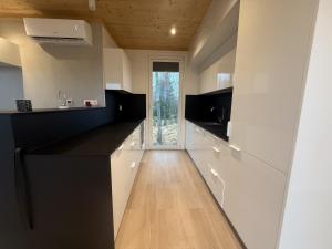 a kitchen with black and white counters and a window at Holiday home in the middle of nature in Knared in Eslared
