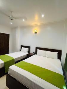 Giường trong phòng chung tại Jaffna City Palace Hotel