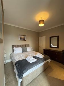 a bedroom with a bed with two towels on it at The Links House Lytham St Annes in Lytham St Annes