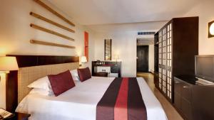 Ένα ή περισσότερα κρεβάτια σε δωμάτιο στο Pearle Beach Resort & Spa