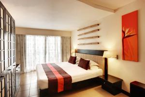 Ένα ή περισσότερα κρεβάτια σε δωμάτιο στο Pearle Beach Resort & Spa