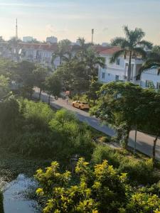 a street with a yellow car driving down a road at Nhật Minh Motel Hải Phòng in Hai Phong +6 photos