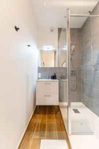a bathroom with a sink and a shower at Le Refugo in Allevard