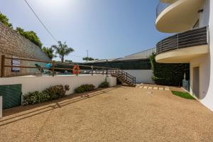 a courtyard of a house with a fence and a staircase at Casa A in Olhos de Água