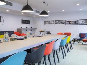 a large room with a long table and chairs at ibis Styles Pforzheim in Pforzheim