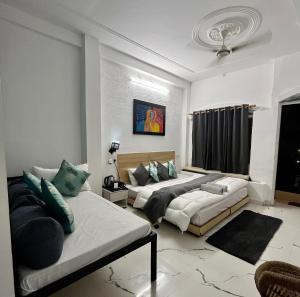 a living room with two beds and a couch at Stay Sukoonn Off Beat Staycation in Mohan Chatti