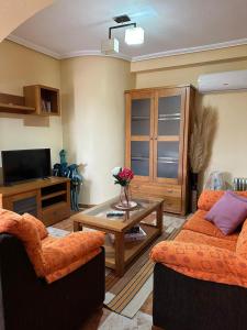 a living room with two couches and a coffee table at Playa Golf II Campoamor in Los Dolses