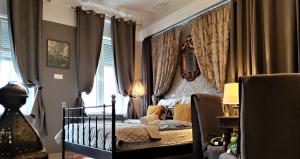 a small child laying on a bed in a bedroom at Central Apartments in Poznań