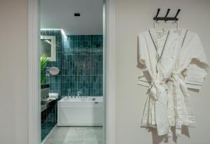 a robe hanging on a rack in a bathroom at Luxurious Olaya Residence in Riyadh +23 photos