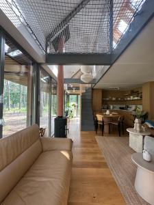a living room with a couch and a table at HATTA Las in Gąsiorowo Duże