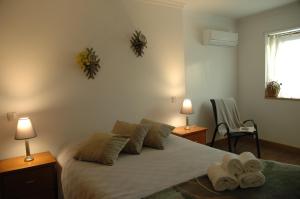 a bedroom with a bed with two towels on it at Casa de l Telar in Duas Igrejas +21 photos