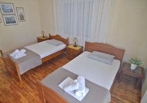a hotel room with two beds and a couch at Helios Apt in Kastoria +12 photos