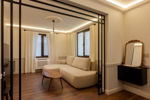 a living room with a couch and a mirror at Private Premium Apartment in Plovdiv in Plovdiv