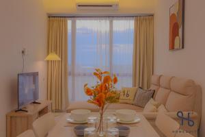 a living room with a couch and a table at Homesuite' Home at Sutera Bay in Kota Kinabalu