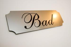 a sign that reads bad on a wall at Ferienhaus Voß, 65260 in Moormerland +14 photos