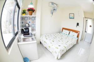 a small bedroom with a bed and a sink at Spring Homestay in Vung Tau