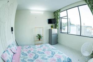 a bedroom with a bed and a large window at Spring Homestay in Vung Tau
