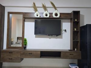 a entertainment center with a tv and a mirror at Golden Tiba in Hurghada