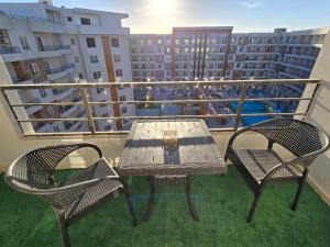 a table and two chairs on a balcony at Golden Tiba in Hurghada