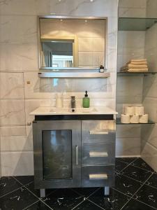 a bathroom with a sink and a mirror at Cozy Apart in Center in Baku