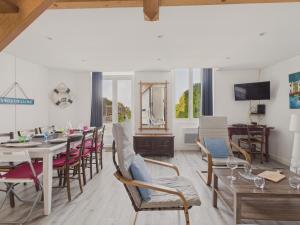 a dining room with a table and chairs at Maison avec accès privatif direct à la plage pour 6 in Pornichet