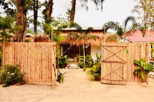 a wooden gate in front of a house at Tides Signature Koh Chang in Ko Chang