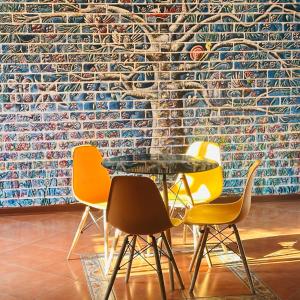 a table and four chairs in front of a wall at MBT Lodge in Polokwane