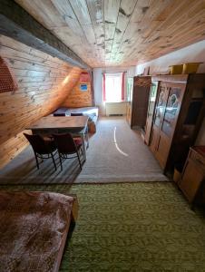 a room with a table and chairs and a bed at Prostorná chalupa v Podkrkonoší ideální pro větší skupiny a aktivní dovolenou po celý rok in Mřičná