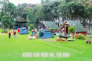 a group of people in a park with tents at Làng Mô Experience Retreat in Sơn Tây +80 photos