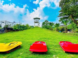 two boats sitting on the grass in a field at Làng Mô Experience Retreat in Sơn Tây