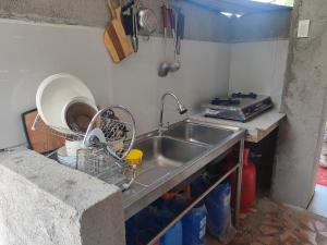 a kitchen with a sink and a counter top at Rustic Haven In Gabaldon Nueva Ecija in Cuyapa +54 photos