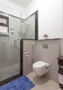 a bathroom with a toilet and a glass shower at Skyline Aramis Apartment Westlands,2bedroom,2baths in Nairobi