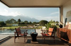 a patio with chairs and a view of a pool at 不晚里予日照金山丨雪山全景度假酒店白沙古镇店 in Baisha