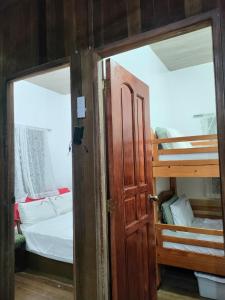 an open door to a bedroom with a bunk bed at Rustic Haven In Gabaldon Nueva Ecija in Cuyapa