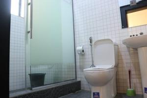 a bathroom with a toilet and a sink at Victorian Bloom hotel and resort in Asaba