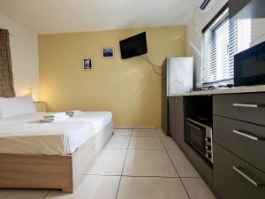 a hotel room with a bed and a flat screen tv at Corner view 4 in Marsaskala