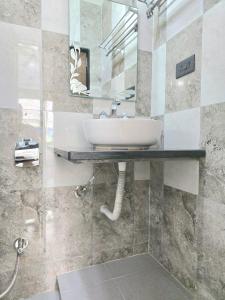 a bathroom with a sink and a mirror at 3 BHK Apartment with swimming pool in Jāmb