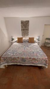 a bedroom with a large bed with two pillows at La Casetta Sulle Mura in Santarcangelo di Romagna