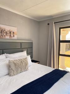 Ένα ή περισσότερα κρεβάτια σε δωμάτιο στο THABAKGOLO GUEST HOUSE