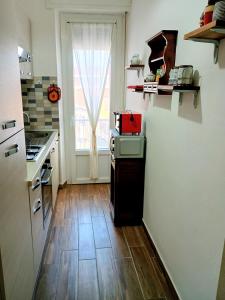 Il comprend une cuisine dotée de parquet et d'une fenêtre. dans l'établissement Le Rose, à Verceil