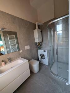a bathroom with a sink and a washing machine at Cozy 2BR Mountain Escape - Molazzana in Molazzana +30 photos